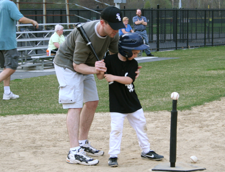 Coach Daddy helping Zan with his batting stance